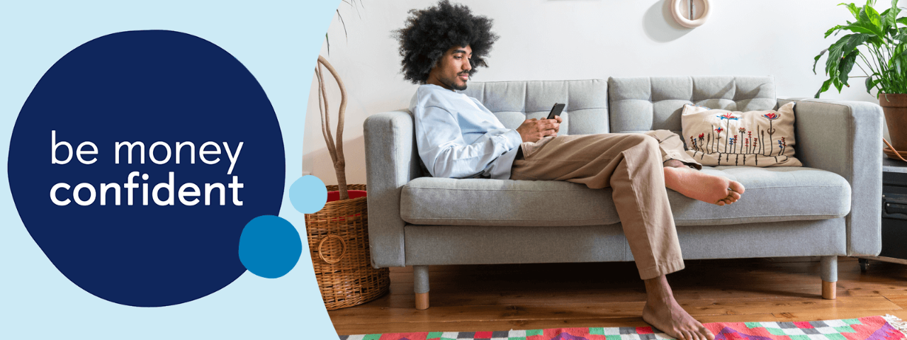 Man on sofa using a mobile phone