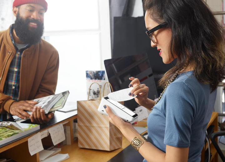 Shop assistant taking a payment from a customer 